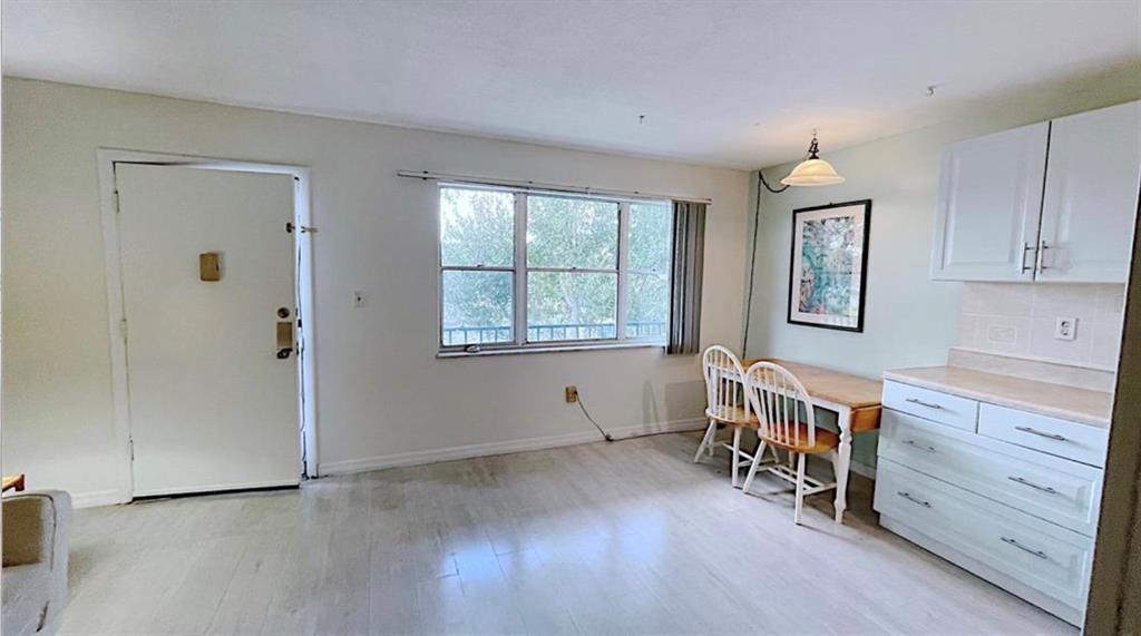 1200 Colonnades Drive, Unit 208 Fort Pierce, FL 34949 - Photo 9 of 31 wooden floor and windows in a room