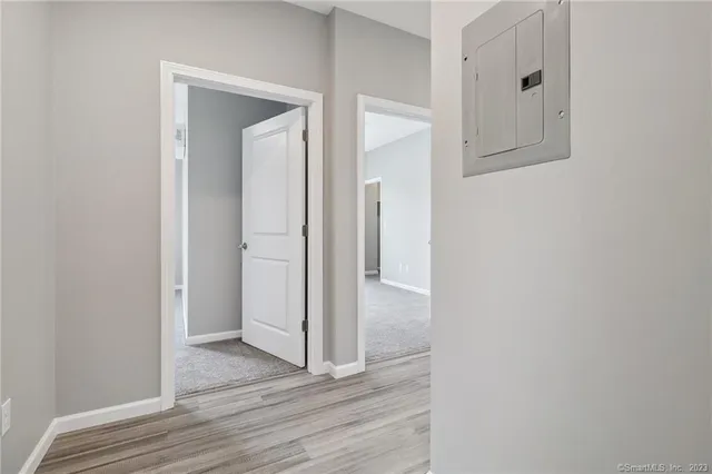 a view of a hallway with wooden floor