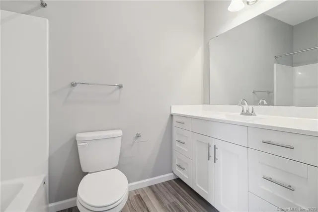 a bathroom with a toilet sink and a mirror