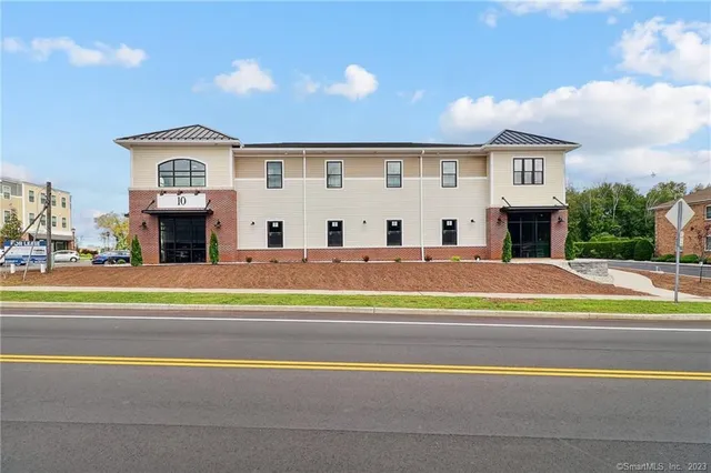 a view of a big house with a area and balcony