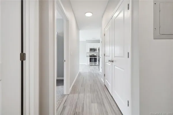 a view of a hallway with wooden floor