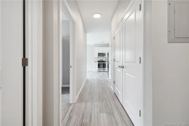 a view of a hallway with wooden floor