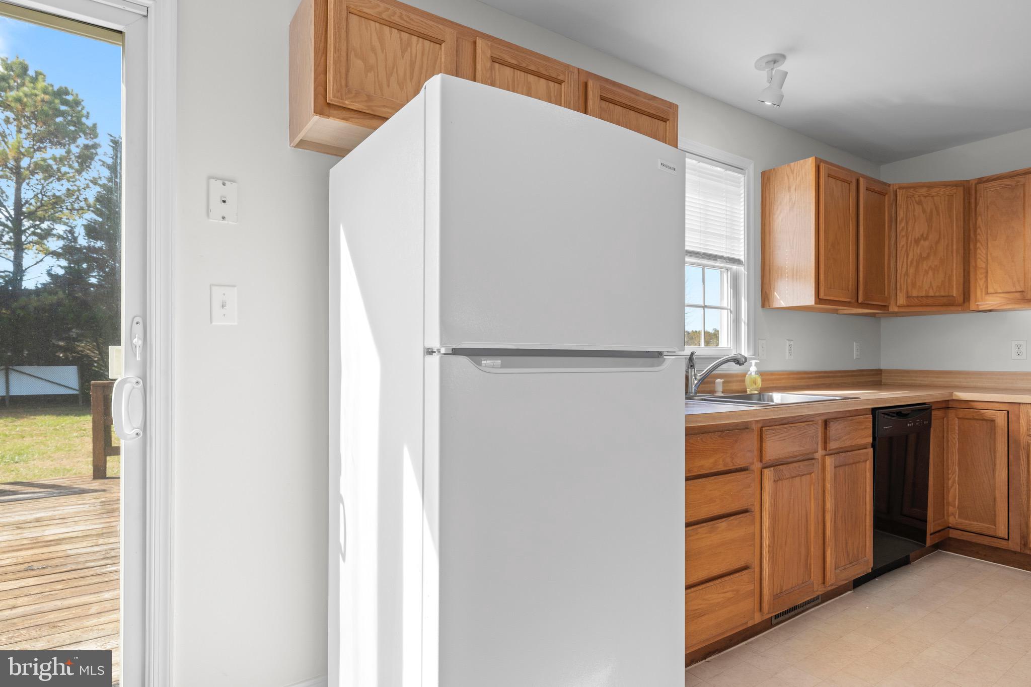 8578 Tuckahoe Road Denton, MD 21629 - Photo 14 of 64 a kitchen with a refrigerator and a sink