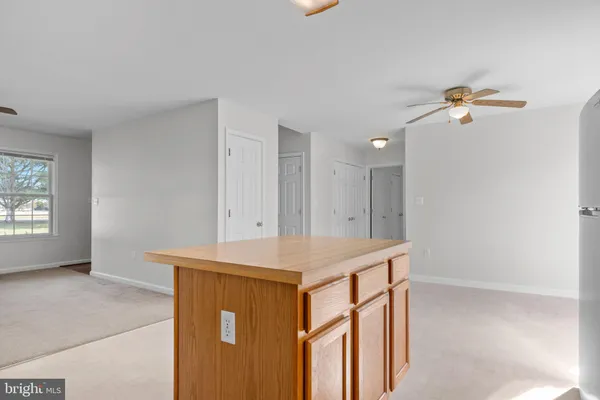 a kitchen with refrigerator a stove a sink and a large window