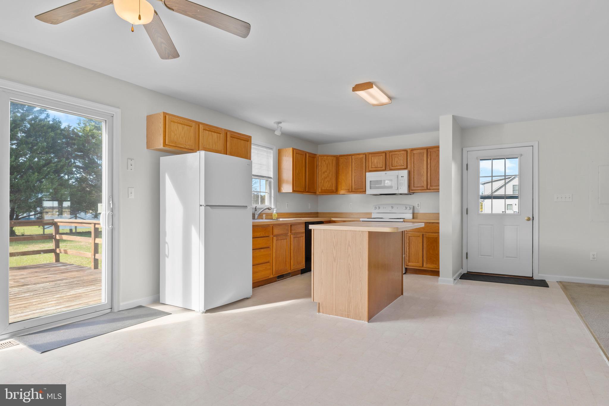 8578 Tuckahoe Road Denton, MD 21629 - Photo 19 of 64 a kitchen with refrigerator a stove a sink and a large window