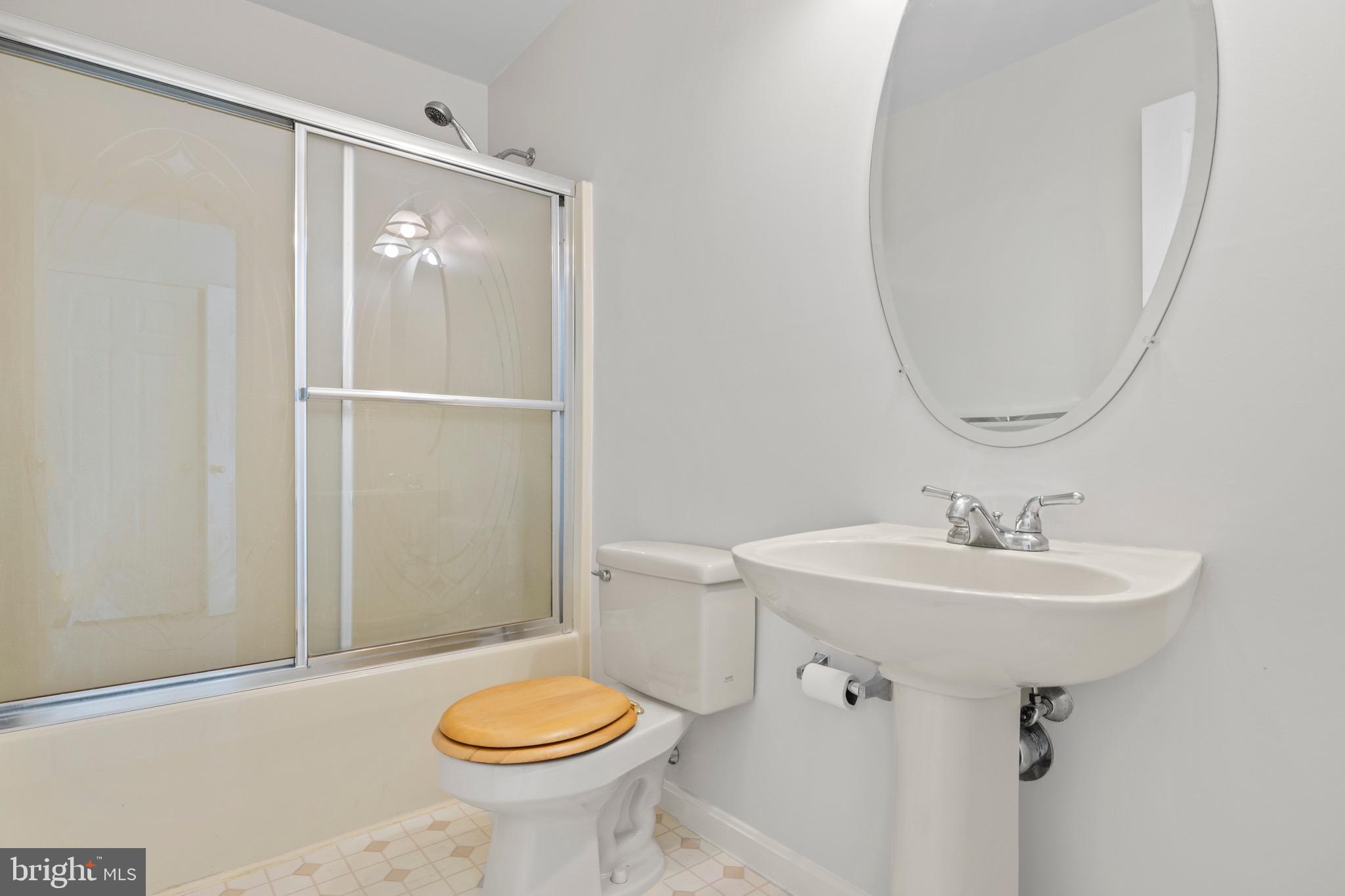 8578 Tuckahoe Road Denton, MD 21629 - Photo 21 of 64 a bathroom with a sink toilet and a mirror