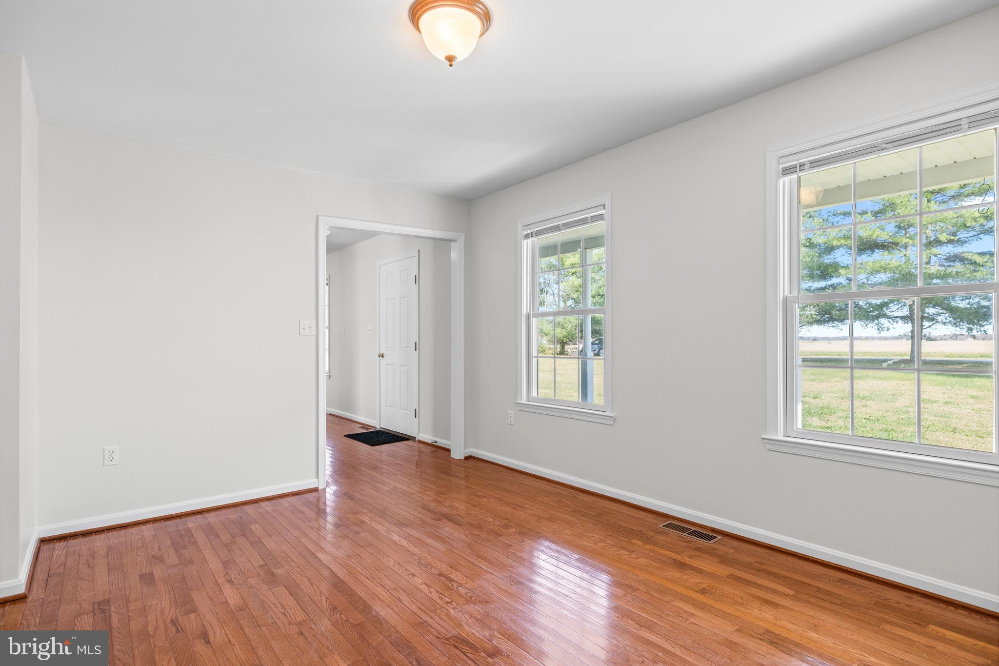 8578 Tuckahoe Road Denton, MD 21629 - Photo 27 of 64 an empty room with wooden floor and windows