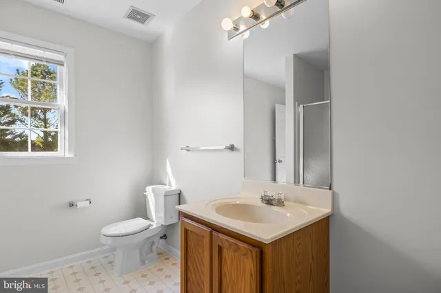 a bathroom with a sink mirror and vanity
