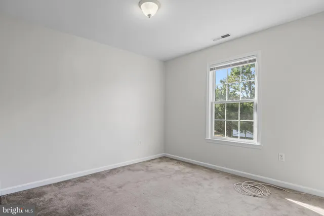 an aerial view of residential houses with outdoor space and lake view
