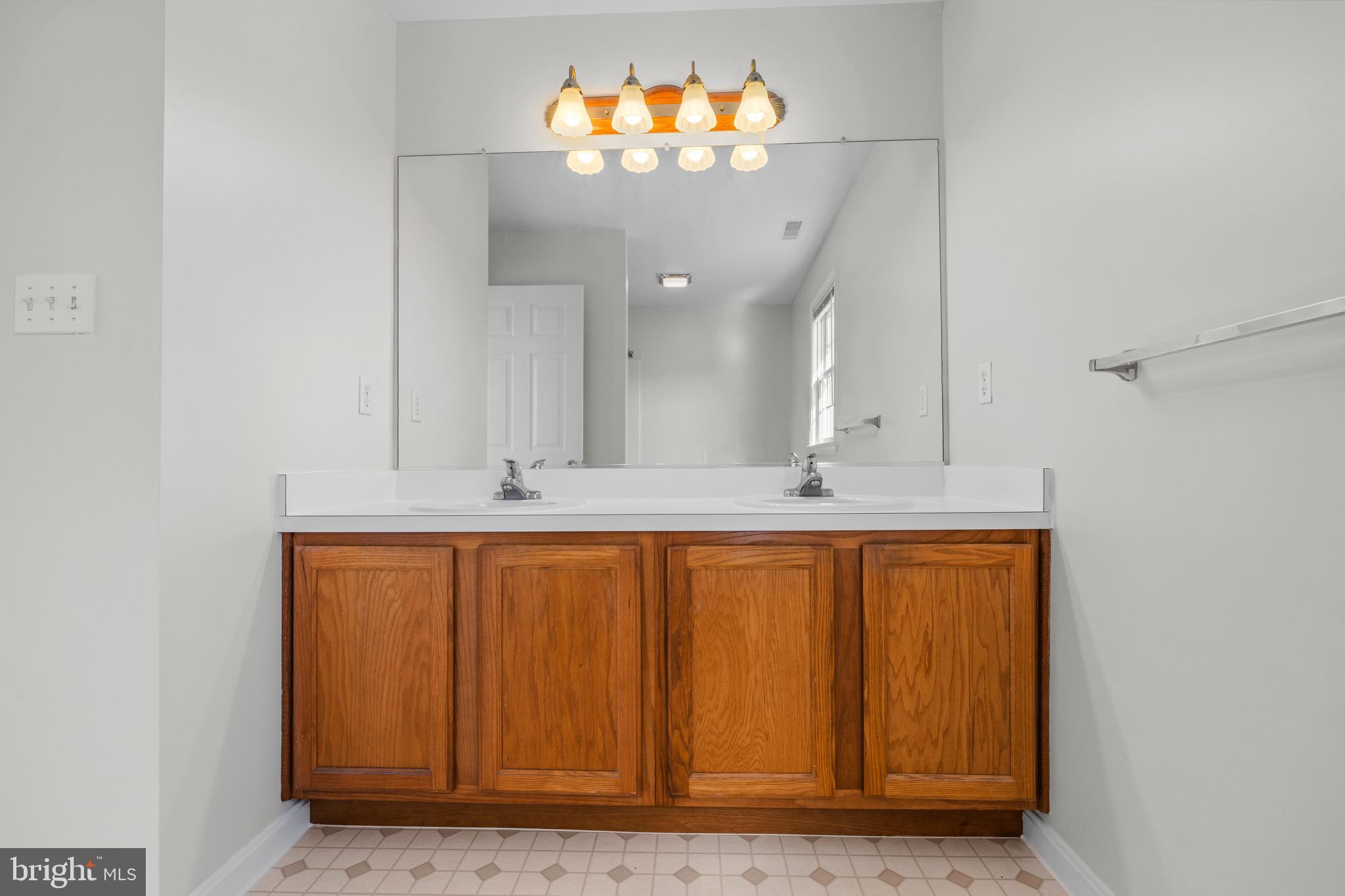 8578 Tuckahoe Road Denton, MD 21629 - Photo 37 of 64 a bathroom with a sink mirror and vanity