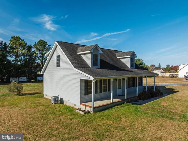 a view of staircase with wooden floor and white walls