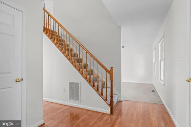 a view of a room with wooden floor and staircase