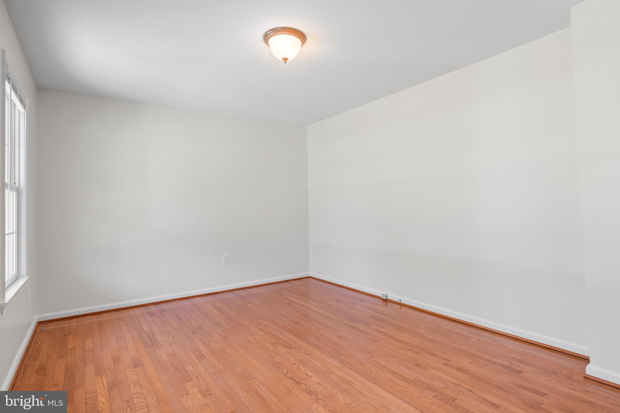 8578 Tuckahoe Road Denton, MD 21629 - Photo 7 of 64 a view of an empty room with wooden floor and a window