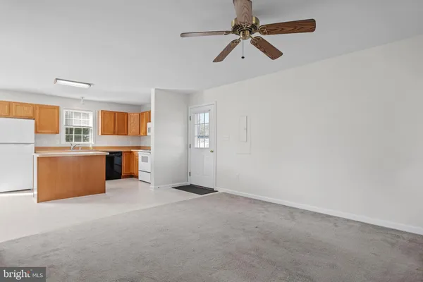 a view of kitchen with stainless steel appliances cabinets and outdoor space