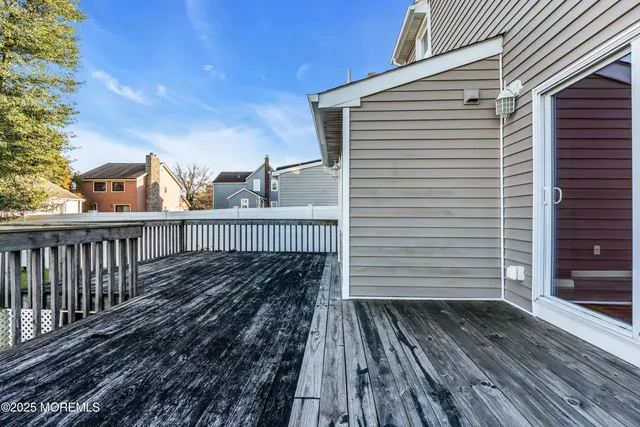 a view of a wooden balcony with wooden floor and fence