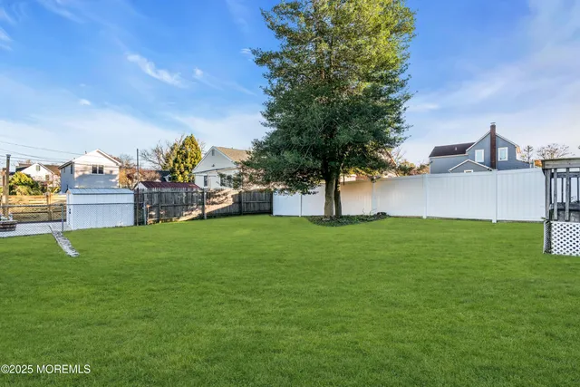 a view of a house with a backyard