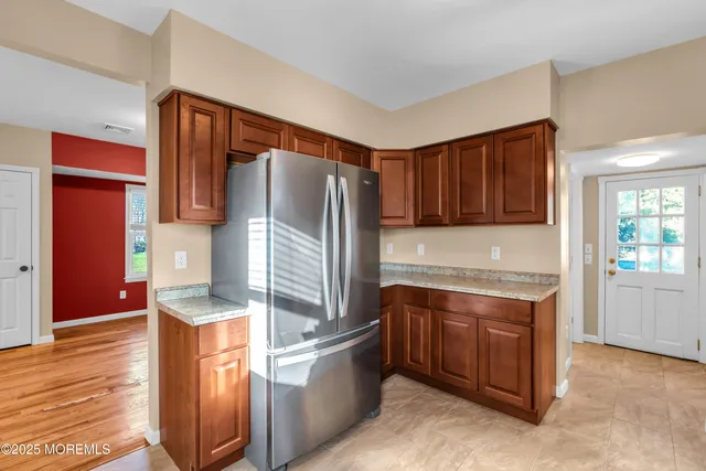 a kitchen with stainless steel appliances granite countertop a refrigerator and a stove