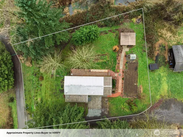 an aerial view of residential houses with outdoor space and trees