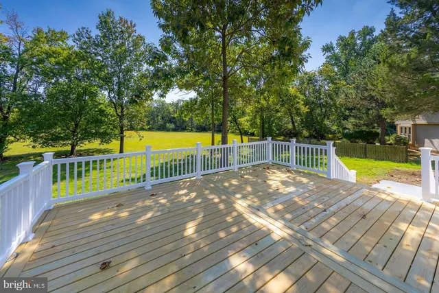 a view of a swimming pool with a patio and a yard