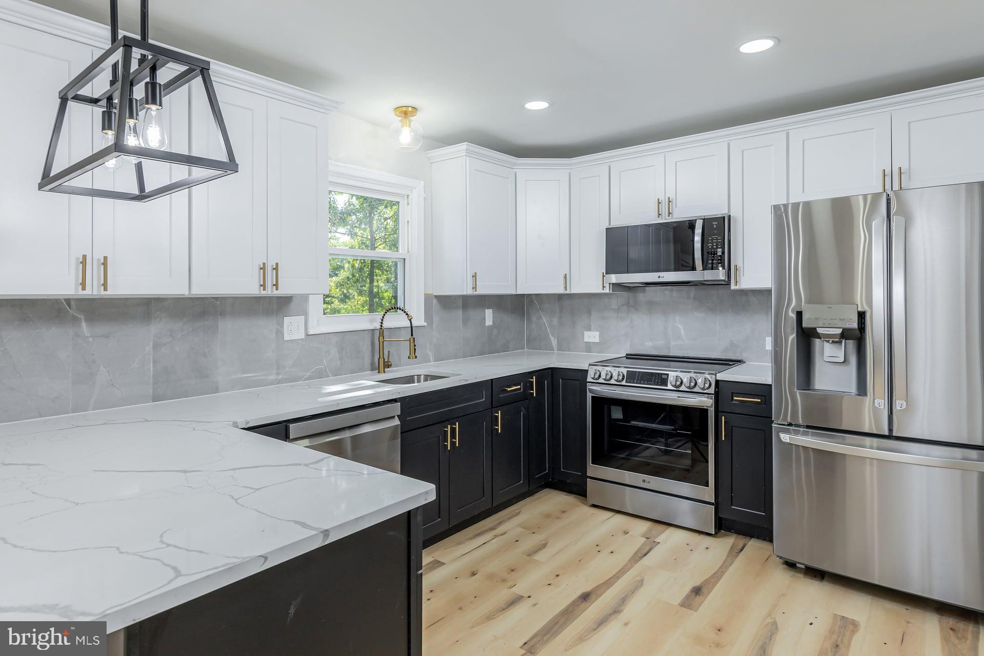 31 Quince Court Mount Laurel, NJ 08054 - Photo 5 of 21 a kitchen with stainless steel appliances granite countertop a stove a sink dishwasher and a refrigerator