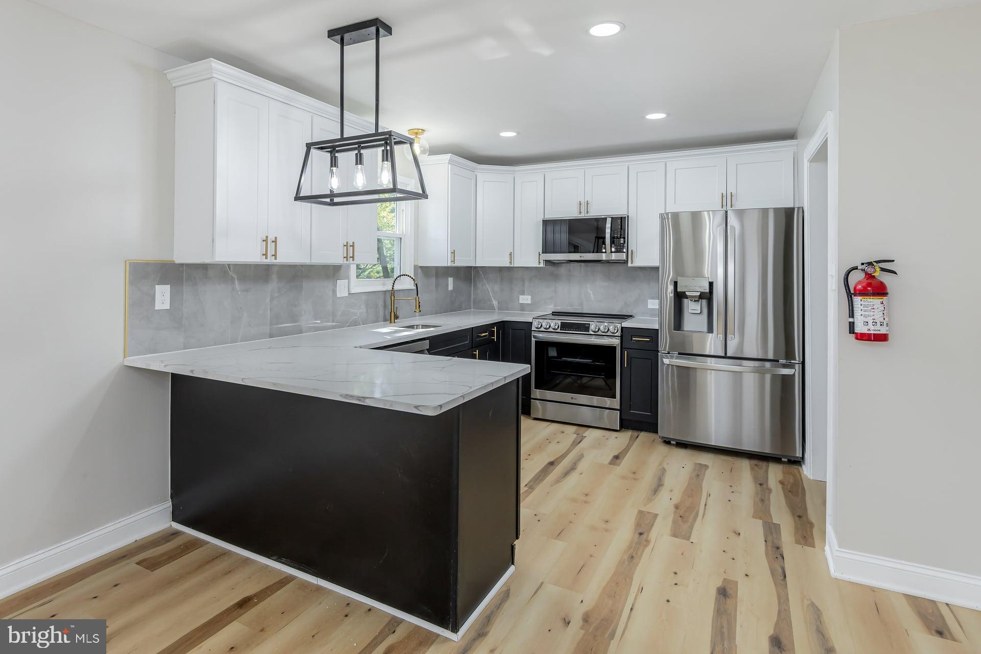 31 Quince Court Mount Laurel, NJ 08054 - Photo 6 of 21 a kitchen with stainless steel appliances granite countertop a sink stove and refrigerator