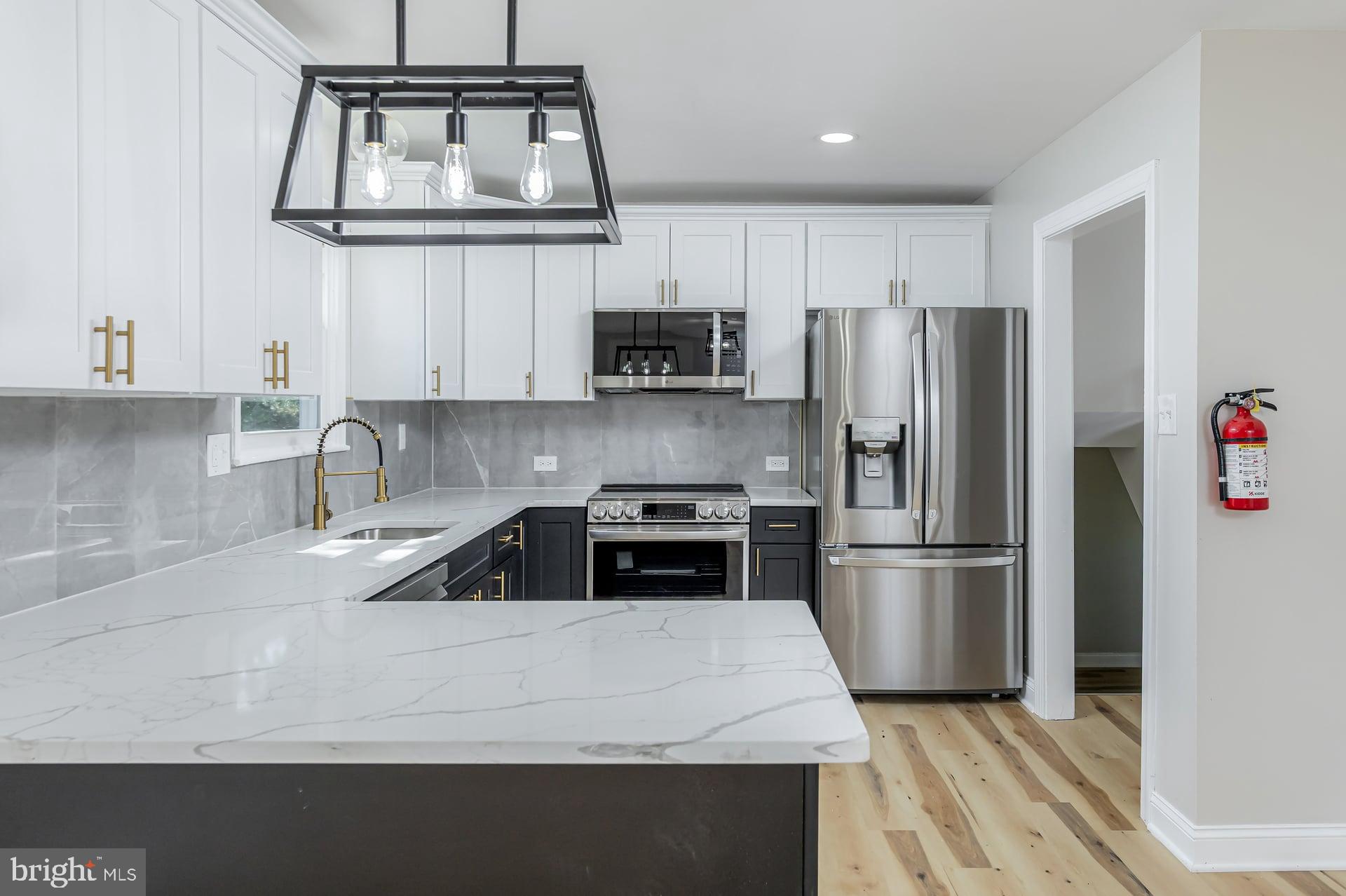 31 Quince Court Mount Laurel, NJ 08054 - Photo 8 of 21 a kitchen with a refrigerator a stove a microwave and cabinets