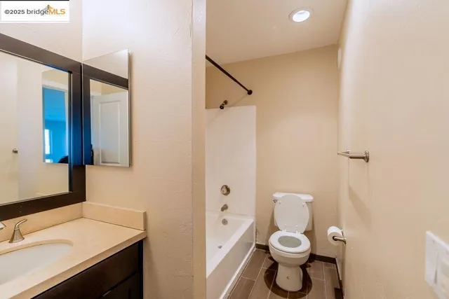 a bathroom with a toilet a sink and a mirror