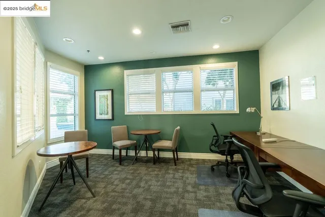 a lobby with furniture and lots of potted plant