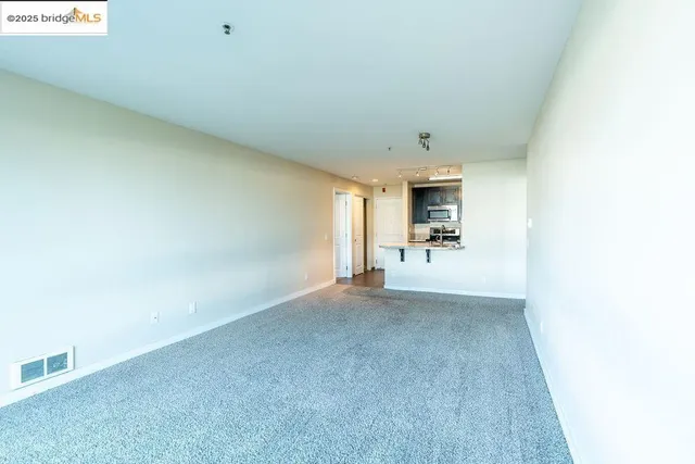 an empty room with windows and closet