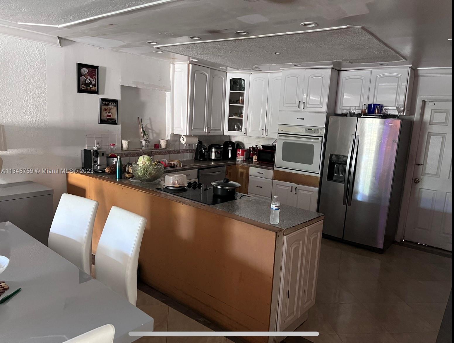 9970 Southwest 30th Street Miami, FL 33165 - Photo 3 of 3 a kitchen with a refrigerator and a sink