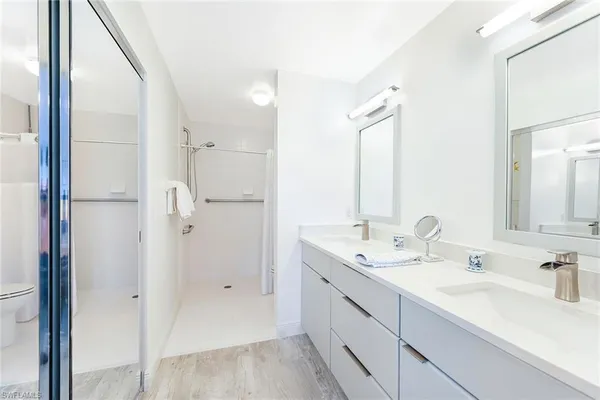 a bathroom with a double vanity sink mirror and double