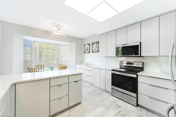 a kitchen with a sink stove and microwave