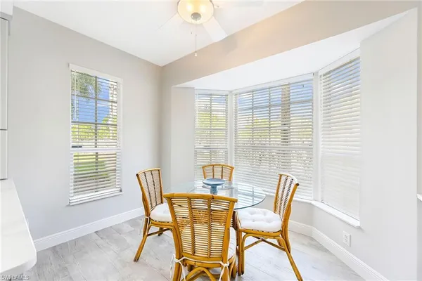 a view of a dining room with furniture and windows