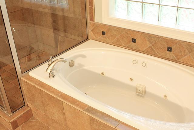 5340 Sherrington Road Murfreesboro, TN 37128 - Photo 9 of 20 Master bathroom features a jetted tub with decorative tile surround and separate glass shower with sitting ledge.
