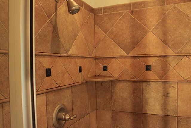 5340 Sherrington Road Murfreesboro, TN 37128 - Photo 10 of 20 Decorative tile shower upgraded brushed nickel faucet head.