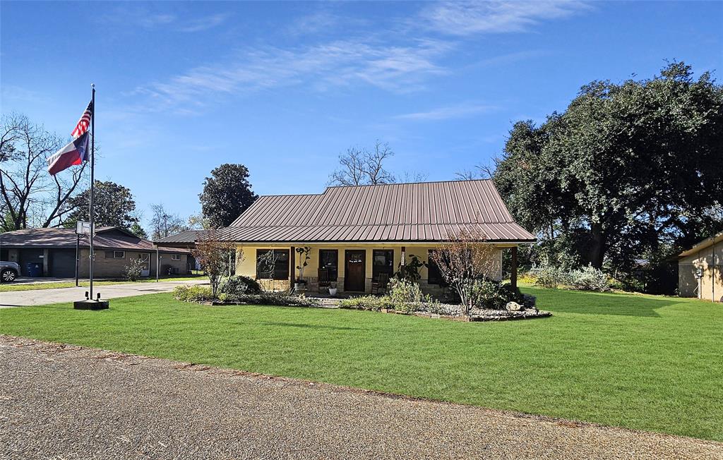 a view of a house with a yard and sitting area
