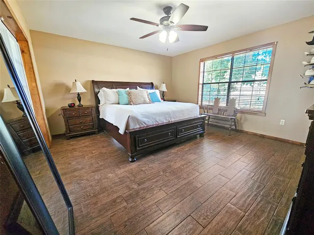 a spacious bedroom with a bed and a large window