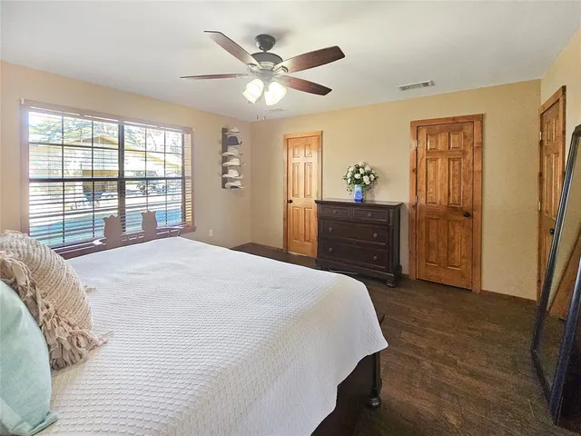 a bedroom with a bed dresser and a window
