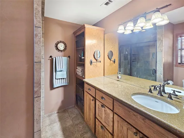 a bathroom with a sink double vanity and a mirror
