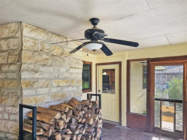 a living room with hardwood floor and a large window