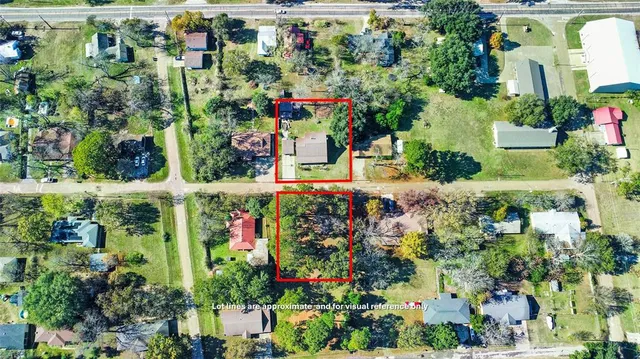 an aerial view of a houses with a yard