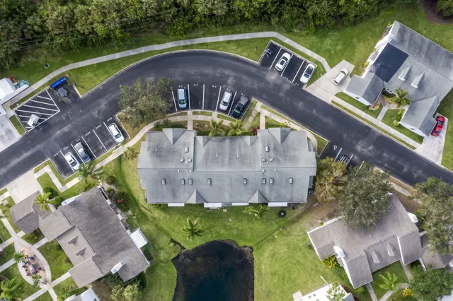 an aerial view of a house with a garden and outdoor seating