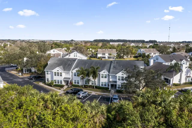 an aerial view of a house with a yard and lake view