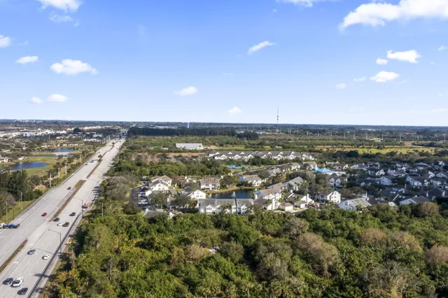 an aerial view of residential houses with outdoor space and river