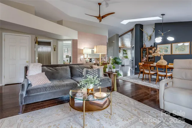 a living room with furniture and a chandelier