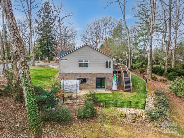 a front view of a house with a yard and potted plants