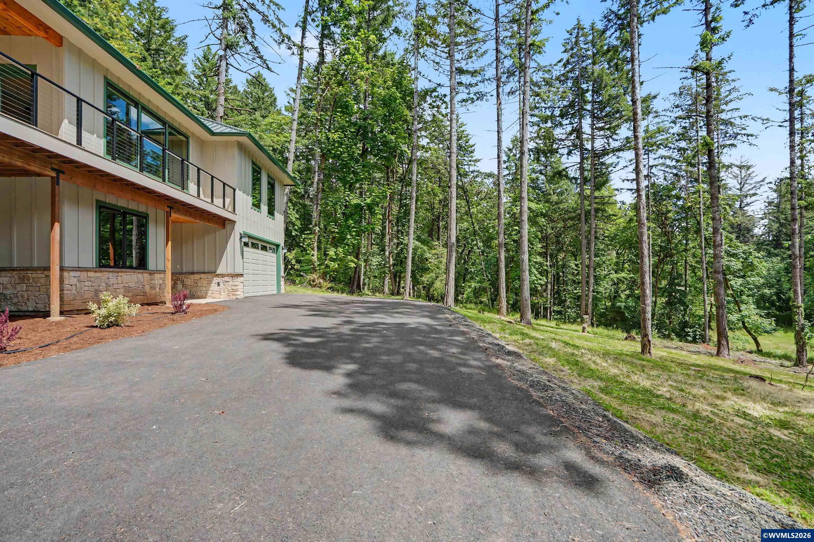 1155 Northwest Country Hills Road Corvallis, OR 97330 - Photo 7 of 48 a front view of a house with a yard and trees
