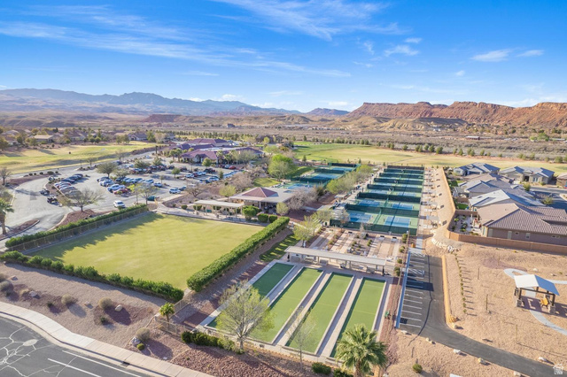 1587 Whitestone Drive St. George, UT 84790 - Photo 29 of 36 Expansive outdoor recreation area featuring multiple tennis courts, bocce ball courts, a large open lawn, covered seating areas, and architectural structures