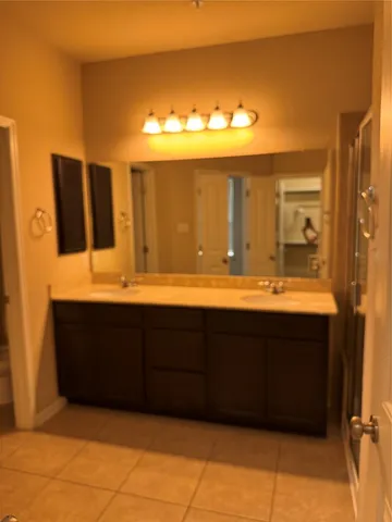 a bathroom with a sink vanity and a mirror