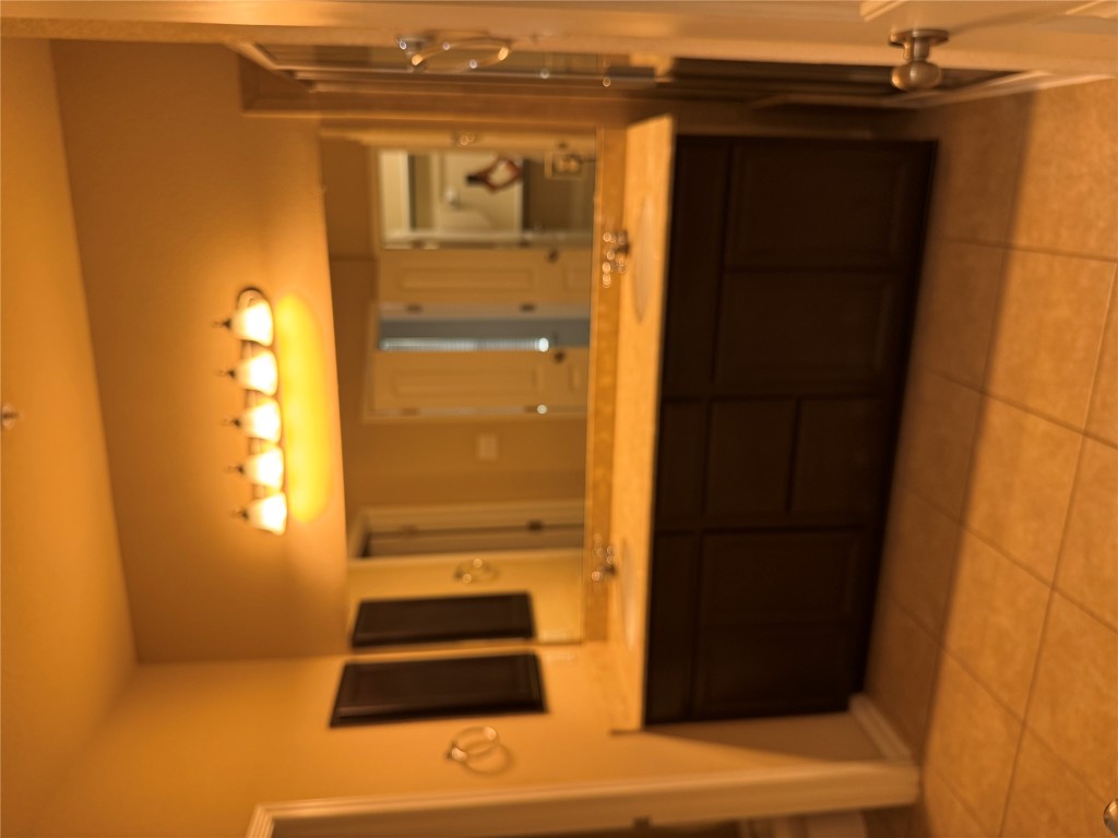 7220 Wyoming Springs Drive, Unit 1301 Round Rock, TX 78681 - Photo 14 of 21 a bathroom with a sink vanity and a mirror